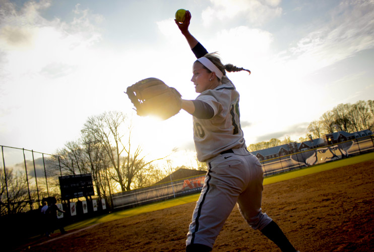 Kara Clauss winds up to send a ball to the home plate as she practices her pitching. Clauss previously pitched the second no-hitter in program history following weeks of rehabilitation after surgery to her right wrist, her pitching arm.