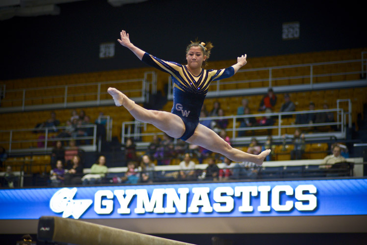 Liz Pfeiler leaps in to the air during her performance on the balance beam, which earned her a team-high score of 9.80.