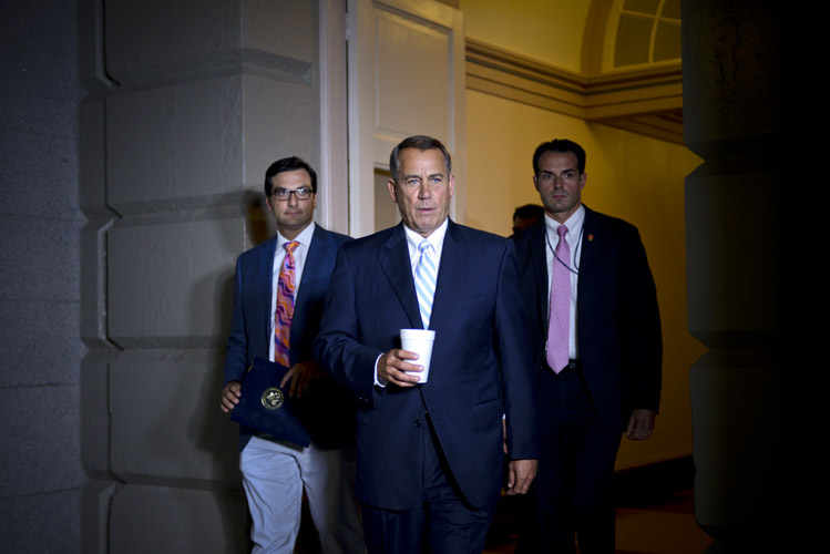 Boehner heads to a caucus meeting after abruptly pulling a bill that provided funding to deal with the surge in children crossing the U.S.-Mexico border. Conservatives revolted at any measure that could be perceived as an endorsement of the Obama AdministrationÕs immigration policy. With Congress scheduled to recess for the summer in just hours, Boehner needed to quickly find a consensus.