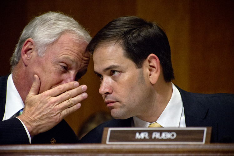 Marco Rubio listens as Ron Johnson of Wisconsin whispers to him during a markup session of the Senate Foreign Relations Committee. Only days earlier, Rubio had officially declared his candidacy to seek the Republican nomination at an event in Miami. But he returned to Washington for the decisive committee vote on a bill that would allow Congress to vote on the nuclear deal being negotiated with Iran.