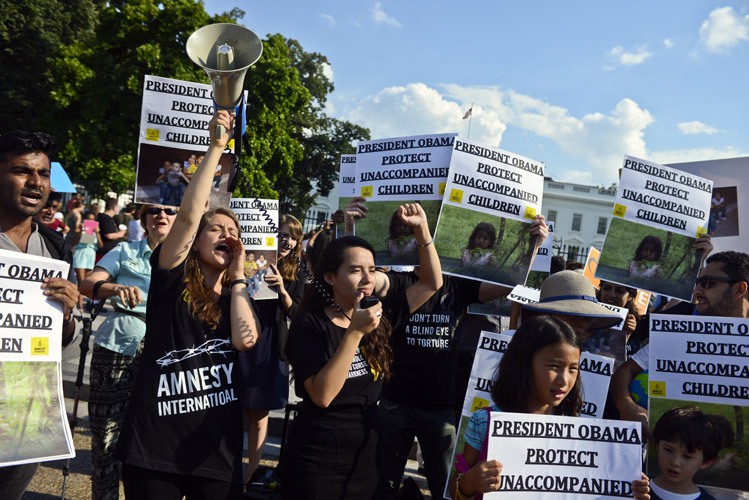 The summer of 2014 presented an unexpected crisis as reports of unaccompanied children from Central America crossing the U.S.-Mexico border swelled. Demonstrators protest in front of the White House, demanding that the Obama Administration provide shelter and greater protections to the growing number of migrant children being held by federal officials.