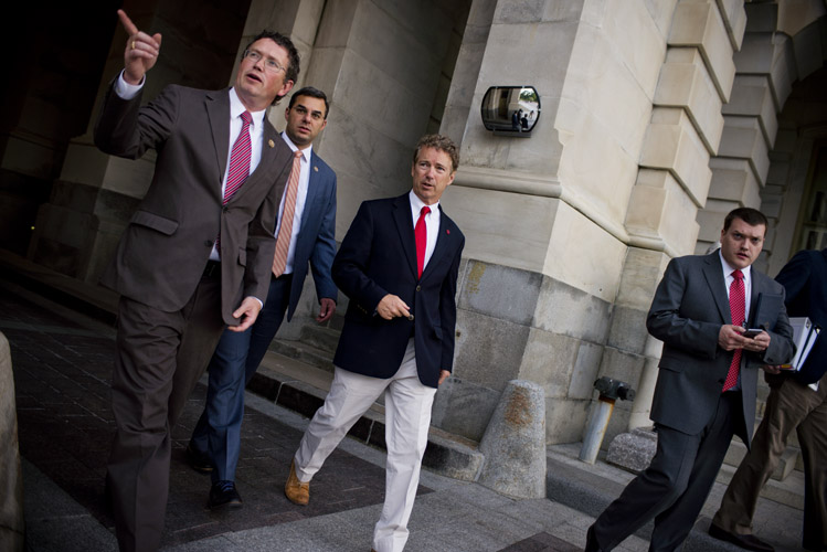 Rand Paul departs from the Capitol following a rare and chaotic Sunday session in which Paul's tactics caused a likely-temporary shutdown of the government mass surveillance program he voraciously opposed. Supporters wearing campaign apparel sat in the Senate galleries as he spoke and his furious condemnation of the domestic spy program garnered him plaudits on social media. He is accompanied by Thomas Massie of Kentucky and Justin Amash of Michigan, two Liberterian-minded members of the House.