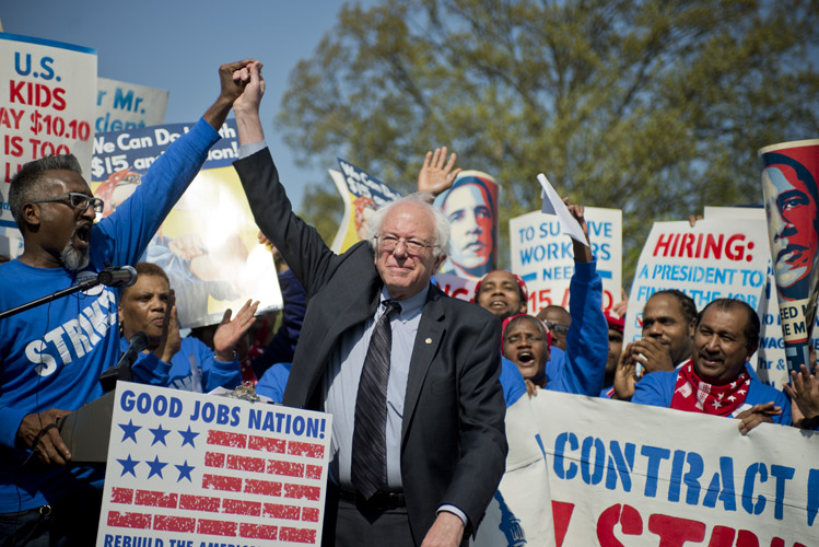 Bernie Sanders is cheered during a rally just outside the Capitol after speaking in support for an increase in the minimum wage to $15-dollars-an-hour. After Sanders announced his campaign, many of the liberal Democrats who gravitated to Elizabeth Warren and unsatisfied with front-runner Hillary Clinton turned their attention towards the self-identified socialist from Vermont.