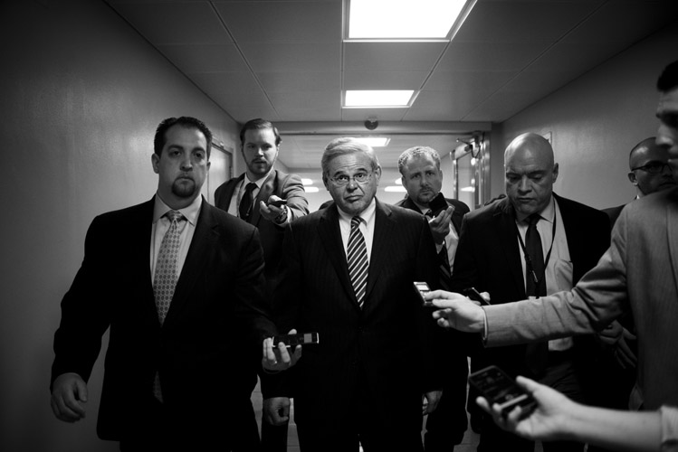 Reporters rush after Sen. Bob Menendez (D-N.J.) as he walks through the Capitol basement, asking him questions on reports that the Department of Justice was planning to indict him on corruption charges. Menendez vehemently denied any wrongdoing.