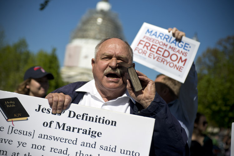 Pastor Larry Hickam expresses his disapproval of same-sex marriage outside the Supreme Court during oral arguments on the issue. Inspired by the 